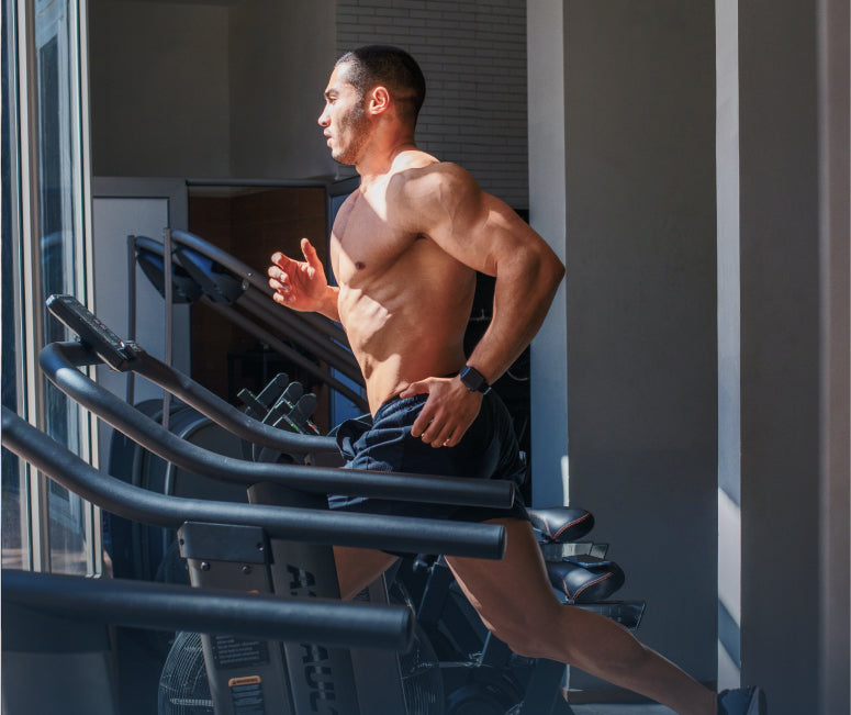 A man running on a treadmill in front of a window.